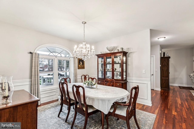 922 Central Ave, Hammonton, NJ 08037 - dining area with dark wood-style flooring, a chandelier, a wainscoted wall, and a decorative wall