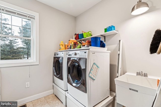 922 Central Ave, Hammonton, NJ 08037 - washroom featuring washing machine and clothes dryer, baseboards, and light tile patterned floors