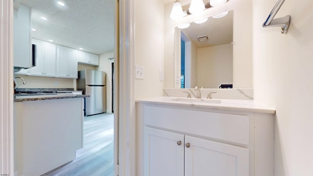 214 Mattix Run Unit 214, Galloway Township, NJ 08205 - bathroom featuring wood finished floors, vanity, recessed lighting, and a textured ceiling