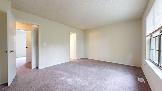214 Mattix Run Unit 214, Galloway Township, NJ 08205 - empty room with carpet flooring and a textured ceiling