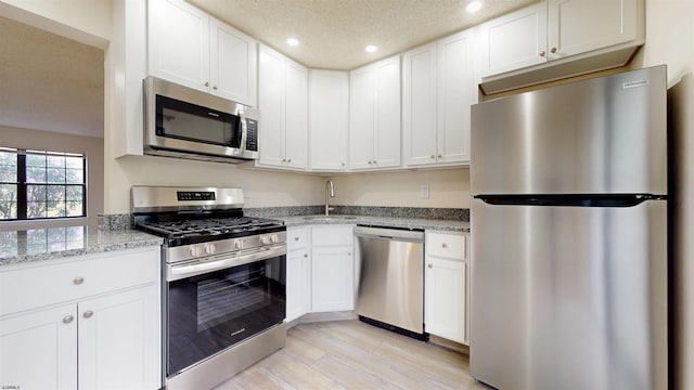 214 Mattix Run Unit 214, Galloway Township, NJ 08205 - kitchen with appliances with stainless steel finishes, recessed lighting, white cabinets, light stone countertops, and a sink