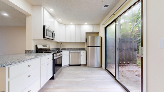 214 Mattix Run Unit 214, Galloway Township, NJ 08205 - kitchen featuring stainless steel appliances, a sink, light stone counters, light wood-type flooring, and white cabinetry