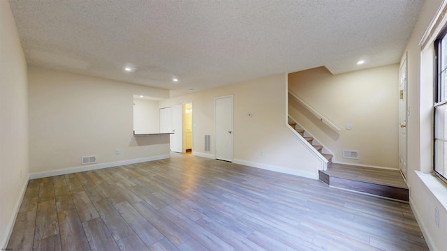 214 Mattix Run Unit 214, Galloway Township, NJ 08205 - unfurnished living room with a textured ceiling, wood finished floors, stairway, recessed lighting, and baseboards