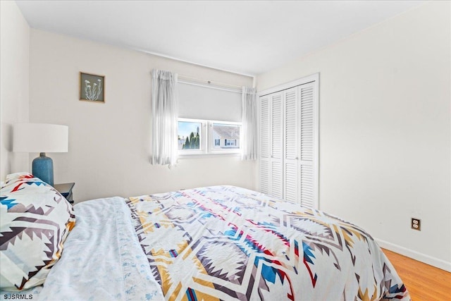 411 N Douglas Ave, Margate, NJ 08402 - bedroom with wood finished floors, a closet, and baseboards