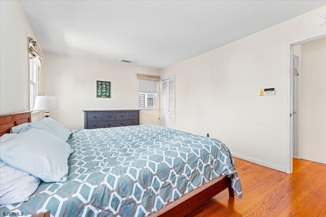411 N Douglas Ave, Margate, NJ 08402 - bedroom featuring wood finished floors, baseboards, multiple windows, and a closet