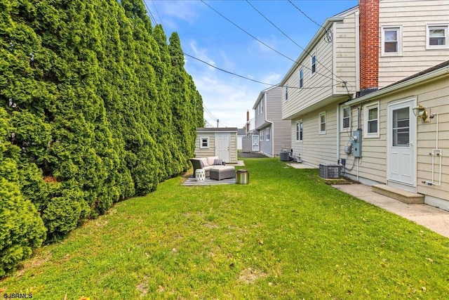 411 N Douglas Ave, Margate, NJ 08402 - view of green lawn featuring cooling unit, outdoor lounge area, and an outdoor structure