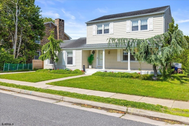 411 N Douglas Ave, Margate, NJ 08402 - traditional home featuring covered porch, a chimney, and roof with shingles