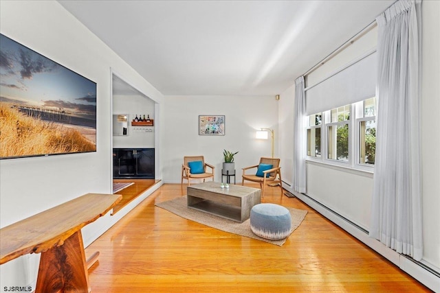 411 N Douglas Ave, Margate, NJ 08402 - living area featuring a baseboard heating unit and wood finished floors