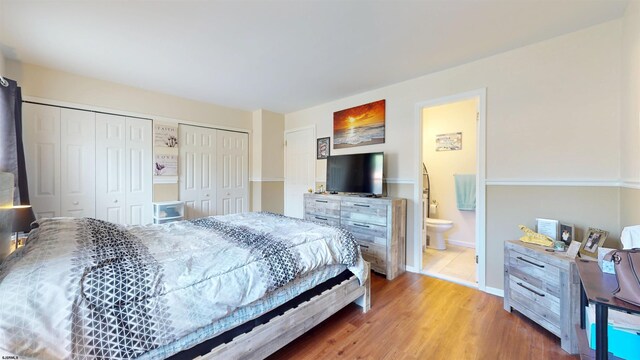 11 Cherokee Dr Unit 206, Galloway Township, NJ 08205 - bedroom with two closets, wood finished floors, baseboards, and connected bathroom