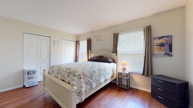 11 Cherokee Dr Unit 206, Galloway Township, NJ 08205 - bedroom with baseboards, two closets, and dark wood-style flooring