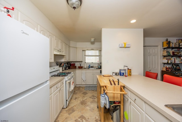 425 Central Ave Unit 1, Ocean City, NJ 08226 - kitchen featuring white appliances, under cabinet range hood, light countertops, white cabinets, and recessed lighting