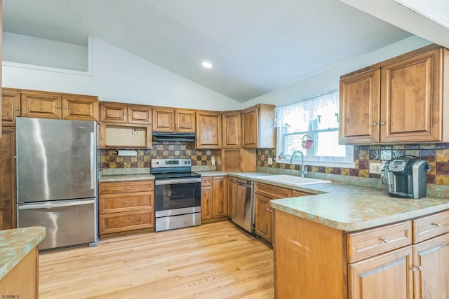 14 Roberts, Marmora, NJ 08223 - kitchen featuring appliances with stainless steel finishes, a sink, under cabinet range hood, brown cabinetry, and vaulted ceiling