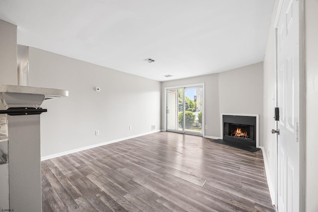 700 N Franklin Blvd Unit 1003, Pleasantville, NJ 08232 - unfurnished living room featuring wood finished floors, a warm lit fireplace, and baseboards