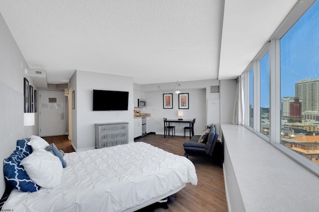 1515 Boardwalk Unit 1004, Atlantic City, NJ 08401 - bedroom featuring wood finished floors, a textured ceiling, expansive windows, and baseboards