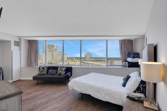1515 Boardwalk Unit 1004, Atlantic City, NJ 08401 - bedroom with wood finished floors, a textured ceiling, baseboards, and a view of city