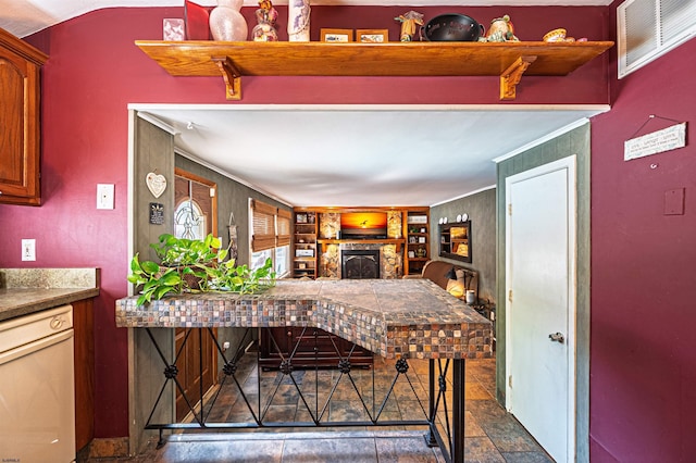 6 Holly Dr, Northfield, NJ 08225 - kitchen with white dishwasher, a brick fireplace, and stone finish floors