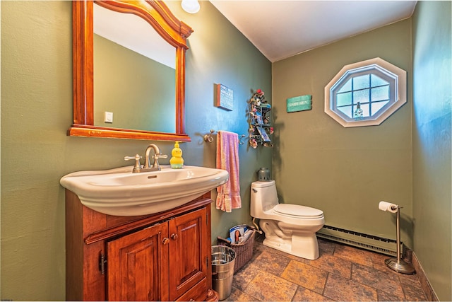 6 Holly Dr, Northfield, NJ 08225 - bathroom featuring baseboard heating, stone tile floors, toilet, vanity, and baseboards