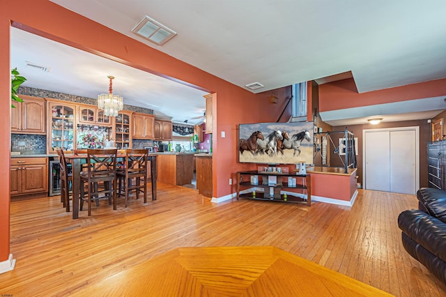 6 Holly Dr, Northfield, NJ 08225 - dining room with a chandelier, light wood-style flooring, wine cooler, and baseboards