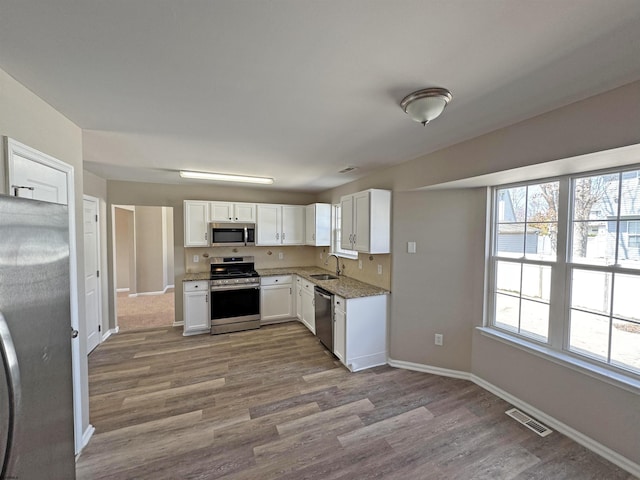 7 Nevis Dr, Egg Harbor Township, NJ 08234 - kitchen featuring stainless steel appliances, a sink, dark wood-style flooring, white cabinets, and baseboards