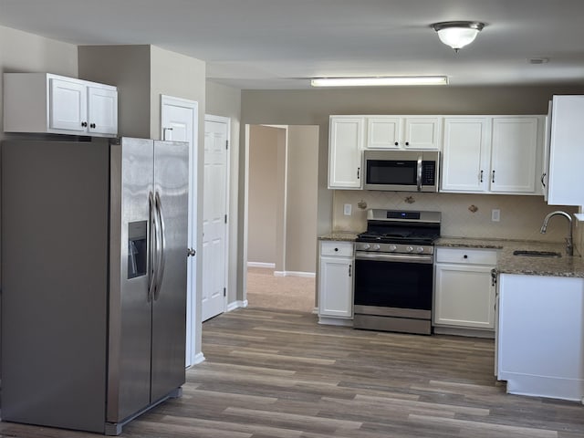 7 Nevis Dr, Egg Harbor Township, NJ 08234 - kitchen with stainless steel appliances, a sink, light stone counters, and white cabinetry