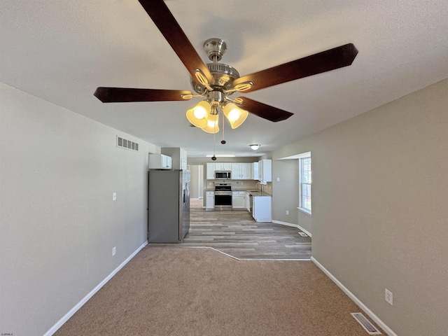 7 Nevis Dr, Egg Harbor Township, NJ 08234 - unfurnished living room featuring ceiling fan, baseboards, light colored carpet, and a sink