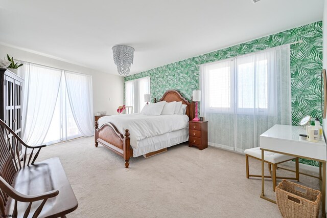 289 40th St Unit B, Brigantine, NJ 08203 - bedroom featuring wallpapered walls, multiple windows, light carpet, and a chandelier