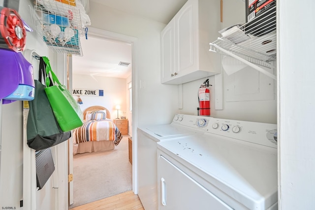 289 40th St Unit B, Brigantine, NJ 08203 - washroom with washing machine and clothes dryer, cabinet space, and light wood-style floors
