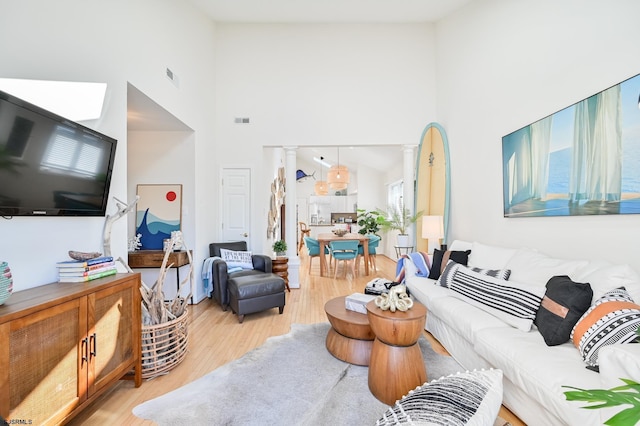 289 40th St Unit B, Brigantine, NJ 08203 - living room featuring a towering ceiling and light wood-style floors