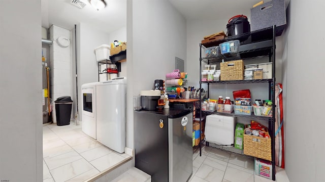 82 Robert Best Rd, Egg Harbor Township, NJ 08234 - laundry area with washing machine and dryer, gas water heater, and marble finish flooring