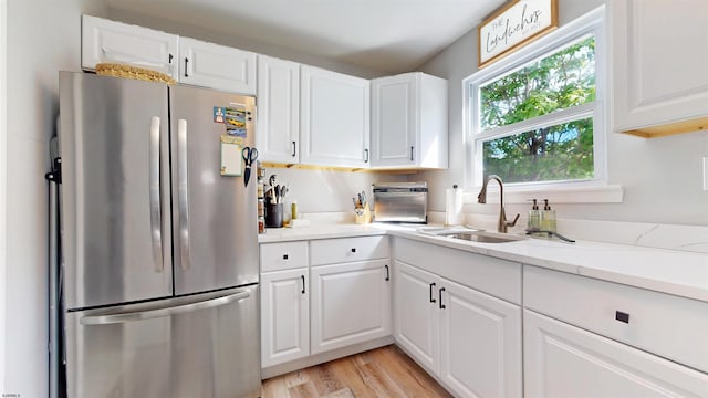 82 Robert Best Rd, Egg Harbor Township, NJ 08234 - kitchen with freestanding refrigerator, white cabinets, and light wood-style flooring
