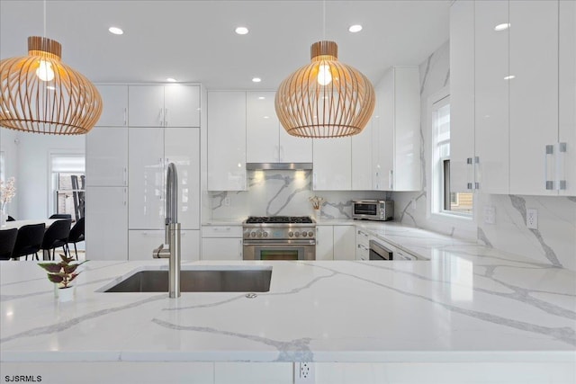 1A N Douglas Ave, Margate, NJ 08402 - kitchen featuring high end stainless steel range, modern cabinets, under cabinet range hood, a sink, and white cabinetry