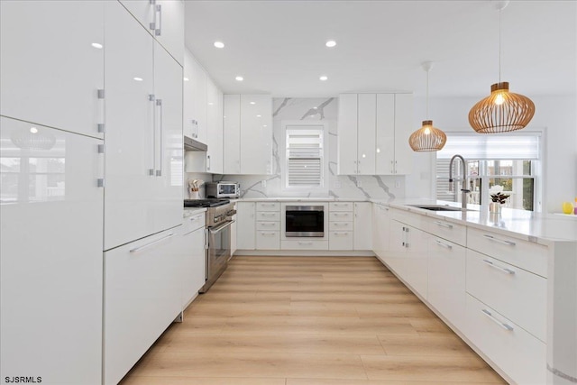 1A N Douglas Ave, Margate, NJ 08402 - kitchen with a sink, a peninsula, modern cabinets, stainless steel stove, and white cabinetry