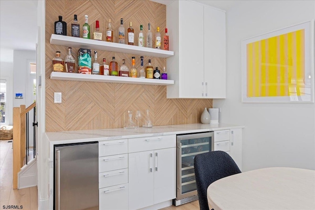 1A N Douglas Ave, Margate, NJ 08402 - indoor wet bar featuring wine cooler, stainless steel refrigerator, and tasteful backsplash