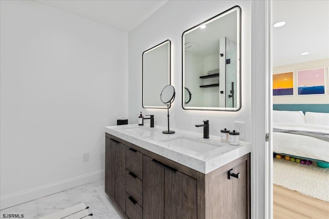 1A N Douglas Ave, Margate, NJ 08402 - ensuite bathroom featuring double vanity, marble finish flooring, baseboards, and recessed lighting
