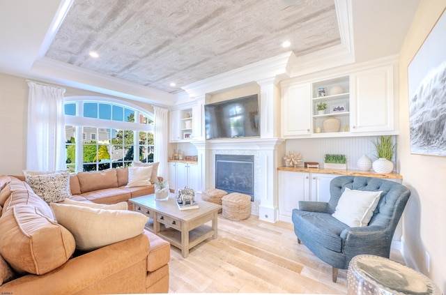 25 S Union Ave, Margate, NJ 08402 - living area featuring a raised ceiling, light wood finished floors, ornamental molding, and a high end fireplace