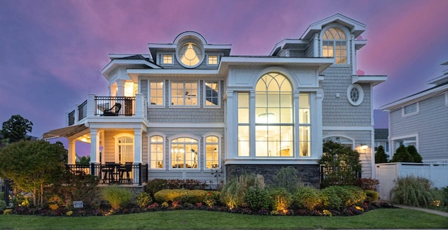 25 S Union Ave, Margate, NJ 08402 - back of property at dusk featuring a balcony, stone siding, and a porch