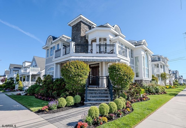 25 S Union Ave, Margate, NJ 08402 - view of front of home featuring a balcony, a residential view, and stone siding