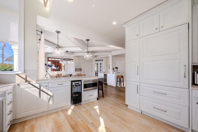 25 S Union Ave, Margate, NJ 08402 - kitchen with a peninsula, light wood finished floors, white cabinets, light countertops, and recessed lighting