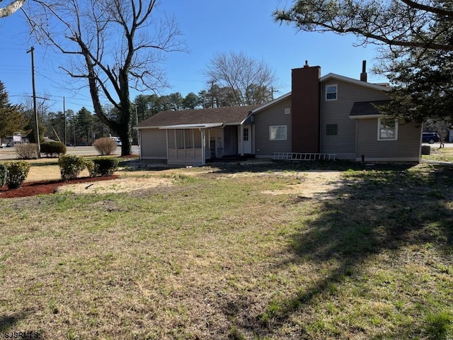909 W White Horse Pike, Galloway Township, NJ 08215 - rear view of house featuring a chimney and a lawn