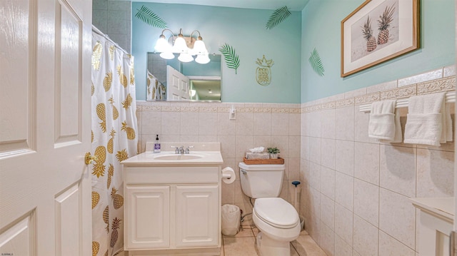 1312 Ocean Ave Unit 1, Ocean City, NJ 08226 - full bathroom featuring toilet, vanity, a wainscoted wall, tile patterned flooring, and tile walls