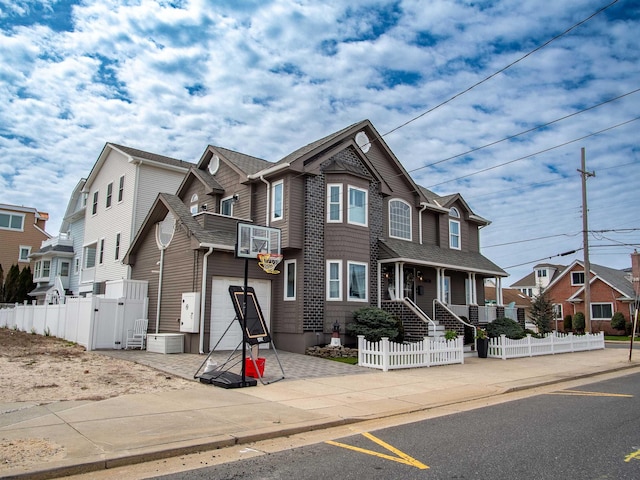 2608 Oberon Ave, Longport, NJ 08403 - view of front of home with a garage, driveway, a gate, a residential view, and a porch