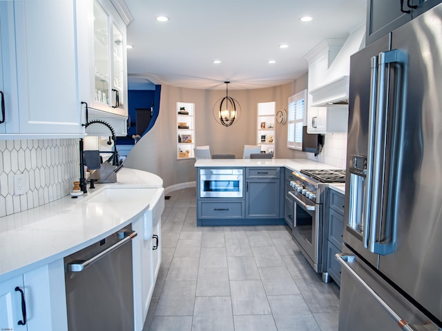 2608 Oberon Ave, Longport, NJ 08403 - kitchen with high end appliances, a peninsula, premium range hood, backsplash, and light countertops