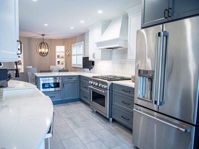 2608 Oberon Ave, Longport, NJ 08403 - kitchen featuring premium appliances, custom exhaust hood, tasteful backsplash, recessed lighting, and a peninsula