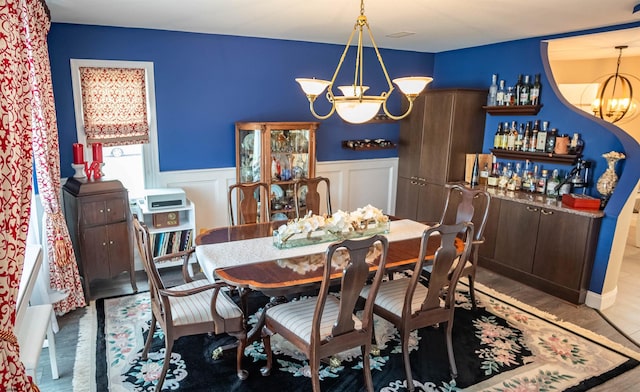 2608 Oberon Ave, Longport, NJ 08403 - dining area featuring a chandelier, a wainscoted wall, wood finished floors, and a decorative wall