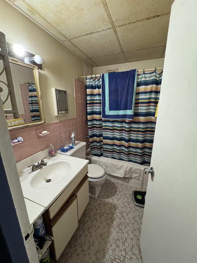 2834 Atlantic Ave Unit 401, Atlantic City, NJ 08401 - bathroom featuring a drop ceiling, toilet, vanity, shower / bath combination with curtain, and tile walls