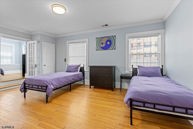 103 S Austin Ave, Ventnor, NJ 08406 - bedroom with ornamental molding, light wood-style flooring, multiple windows, and baseboards