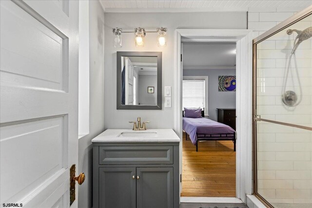 103 S Austin Ave, Ventnor, NJ 08406 - ensuite bathroom featuring a shower stall, vanity, crown molding, and wood finished floors