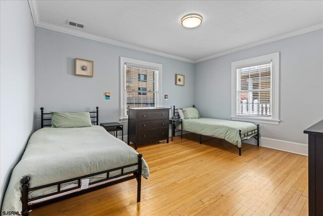 103 S Austin Ave, Ventnor, NJ 08406 - bedroom featuring crown molding, light wood-type flooring, and baseboards