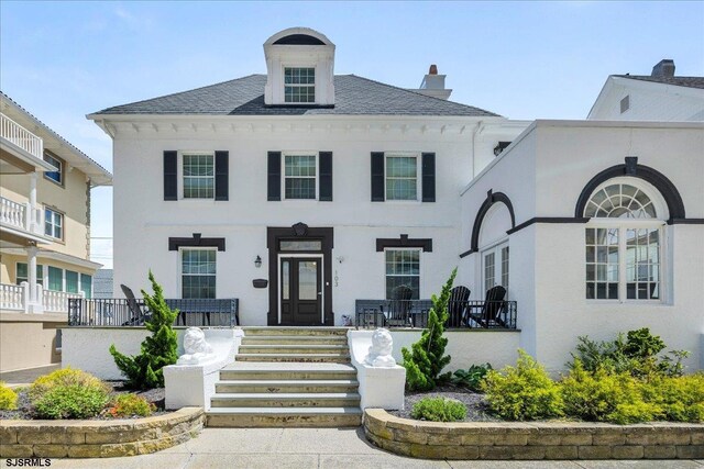 103 S Austin Ave, Ventnor, NJ 08406 - view of front facade with covered porch, a chimney, and stucco siding