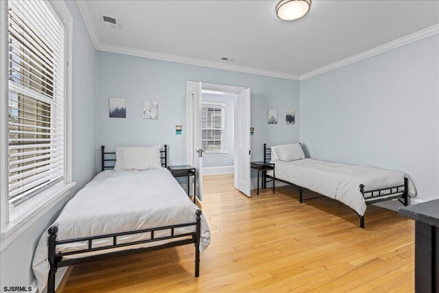 103 S Austin Ave, Ventnor, NJ 08406 - bedroom featuring light wood finished floors, ornamental molding, and baseboards